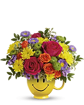 Bright assortment of colorful flowers including roses, lilies, and daisies